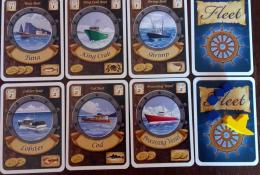 Karty lodí, značka prvního hráče a přepravky ryb