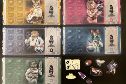 Desky hráčů s žetony bodů a figurkami rakety a UFO + malý žeton havárie